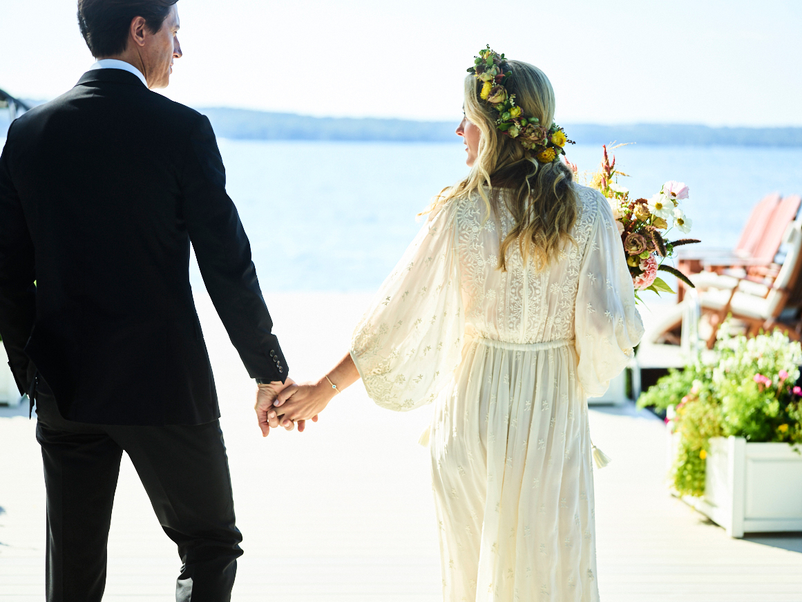 husband and wife on dock by lake